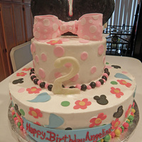 Minnie Mouse Cake Minnie Mouse Cake, Butter cream frosting with fondant decor, fondant covered Rice Crispy Treat Ears and Chantilly filling