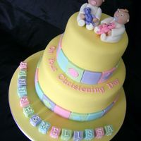 Twins Christening Cake Christening Cake for Twins Hannah and Melissa, 9 inch and 6 inch with fondant 'blocks' and gumpaste babies on top. Cake was...