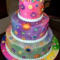 Tie Die With Flowers Surprise 60th birthday party. Gum paste adornments, air brushed colors on cake and board.