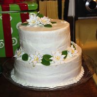 White Poinsettias Buttercream tiered cake with white Royal Icing poinsettias with gold tips. This was my first tiered cake. The class was on Christmas Eve so...