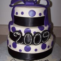 Graduation Cake This cake is made with the WASC recipe and Marshmallow fondant. The layers are 12, 10, and 8 inches. The black ribbon is real ribbon.