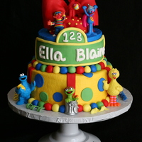 Sesame Street Cake Buttercream covered with fondant decorations and store bought toys.