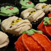 Spooky Cupcakes Dark chocolate cupcakes filled with banana cream and frosted in cream cheese frosting.
