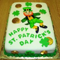 St_Pat_Cake_2009_20A.jpg Cake is covered in rolled fondant. Decorations are fondant cut-outs and chocolated covered coins. Leprechaun is fondant cut-out and hand-...