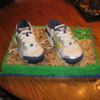 Mizunos Trail Running Shoes Rice Krispie treats covered in fondant for the running shoes sitting on a sheet covered in choc and reg graham crackers for the dirt.