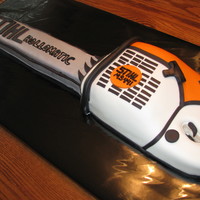 Chainsaw This grooms cake was all chocolate cake, covered in MMF to match the grooms actual chainsaw