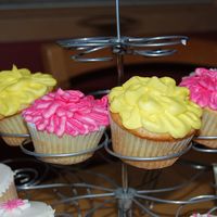 Flower Cupcakes working on my mother day flower cupcakes. the pink one is a carnation and the yellow is supposed to be like a daffodil. used buttercream...