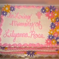 Img_0011.jpg Cake done for a memorial/fundraiser for a baby who passed away. 1/2 w/ 1/4 sheet on top, marble cake, buttercream icing and fondant flowers...