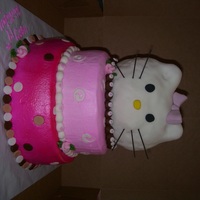 Hello Kitty Stacked cake covered in butter cream and airbrushed. Kitty head made out of rice krispy