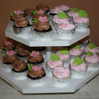 Birthday Cupcakes Chocolate fudge cupcakes with choc BC and vanilla cupcakes with strawberry BC...with fondant accents
