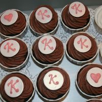 Chocolate Overload Cupcakes chocolate cupcake with white chocolate ganache filling and rich chocolate icing - fondant disc with pink colored chocolate initial on top
