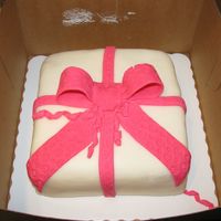Present Cake my first covering a square cake with fondant, first fondant bow. didn't get the bottom border on the cake before it got devoured by...