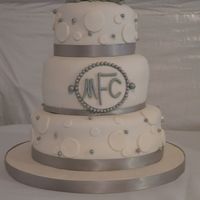 Silver Heart Wedding my first ever wedding cake....6, 8, 10 rounds covered in MMF, gumpaste and MMF accents, silver ribbon...gumpaste accents covered with...