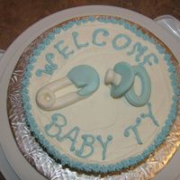 Baby Ty Vanilla cake with Buttercream icing and fondant soother and diaper pin.a quick cake i did up for a friend of a friend and her new baby boy...