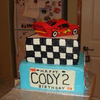 2 Nd Bday 2 layer cake , vanilla with Pina colada filling and chocolate with butterscotch filling . Car on top is carved from cake ( loaf pan) All...