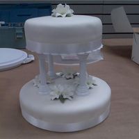 Wilton's Class Wedding Cake First go at a wedding cake. Just learned lilies and had so many practice ones that i used them on this!!