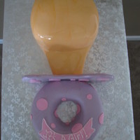 Baby Pacifier Pacifier Cake, covered in fondant. Strawberry cake and yellow cake with bc icing.