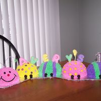 Caterpillar I used the sports ball Wilton pan and made this caterpillar cake. Sugar cookies were used to spell the name.