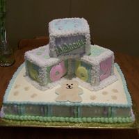 Baby Blocks And Teddy Bear Babyblock cake with a teddy bear theme. Almond coconut cake with Bavarian cream filling. BC wtih fondant letters