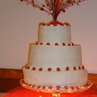 Round Wedding Cake Choc cake w/staw filling, crusting cream cheese frosting. Flowers are royal icing. Had a hard time w/ creamcheese frosting, couldn't...