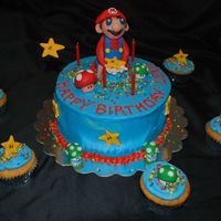 Mario Birthday Cake! Hand-sculpted fondant Mario cake, with matching cupcakes. :)