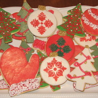 Christmas Cookies Sugar cookies covered in fondarific with royal icing accents and sugar/peppermint/pearl details.