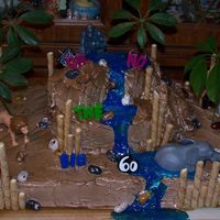 Jungle Cake cookies for the bamboo. piping gel with pearl dust mixed in for the waterfall. candy rocks. real plants for the trees. white cake with...