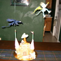 How To Train Your Dragon Birthday White cake covered with buttercream and mmf.. castle front is made of rkt, all edible except for the lil guy on top...not the best castle...