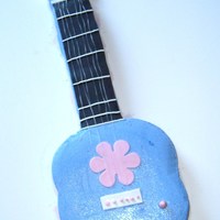 Guitar chocolate cake and buttercream, fonant accents, used dental floss for strings(got the idea from here) my first guitar I hope to do better...