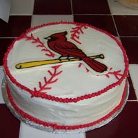 Cardinals Simple 9 inch round white cake with buttercream icing. Used candy melts to make the redbird.