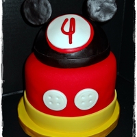 Mickey Mouse Chocolate cake with MacMom's BC Flavored Fondant with candy melts added. The Mickey hat is styrofoam covered in fondant. Goes with the...