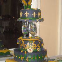 Mardi_Gras_Prom_And_Cake_025.jpg Four (8, 10, 14 in round and 16 x 16 in square) tiered cake with Hurrican glasses (prom favors) used to divide layers. All gumpaste and...