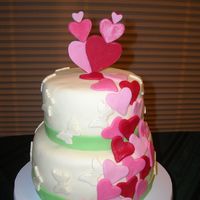 Falling In Love! White pudding cake with cream cheese pudding. Iced with buttercream icing. Covered with Marshmellow Fondant and all decorations made with...