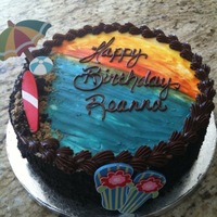 Tropical/beach Birthday Chocolate cake with chocolate mousse frosted in ganache. Sand was crushed honey graham crackers. Items on cake were purchased at local...