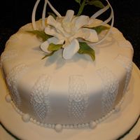 Jodi's Cake fondant covered cake with gumpaste flowers and decorations.