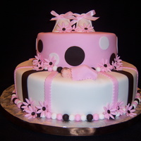 Polka Dots And Stripes 12 & 8" teirs. Fondant covered with accessories. Booties are fondant and so is the baby.