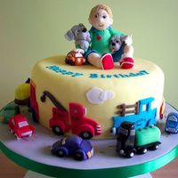 Boy With Toys This cake is a wonderful theme for a young boy, with all the cars he loves.It is an 8in round cake done on a 12in board