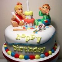 Mother Little Helpers A very cute boy and girl making a mess when icing the cake