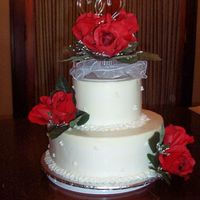 Round White Wedding Cake With Red Roses This was only the 2nd wedding cake I have made. I tried the upside down icing method for the first time and I do like the crispness of the...