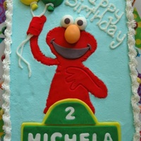 Elmo Requested for a little girl's second birthday party. Two 1/4 vanilla sheet cakes with whipped chocolate filling. Iced in buttercream...
