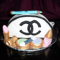 Chanel Makeup Purse Cake this was a 8x2 cake pan cut in half put together with buttercream and coverd with fondant....