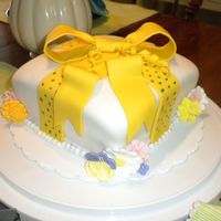 Wilton Course 3 Lesson 2 Fondant Gift Cake I added my own twist by adding royal icing flowers and polka dots.