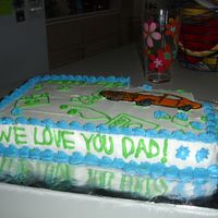 Father's Day Cake Sheet cake iced in buttercream and the car was done in color flow. All my dad's hobbies are represented on the cake.
