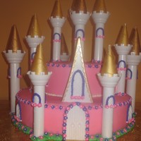 Castle Cake I made this castle cake for a friend whose daughter who just turned 1yr old.Bottom cake is a 14" devils food ake with buttercream...