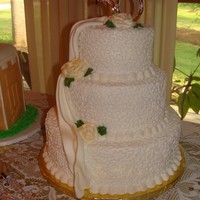 50Th Anniversary Cake All yellow cake with BC icing. Cornelli lace designs, BC roses, fondant drapery.