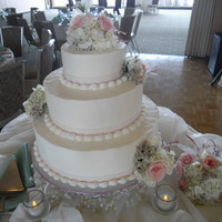 Sweet Simplicity 6-10-14 white vanilla cake with vanilla BC. Flowers done to match bride's choices.Still need work on those sharp edges, but I'm...