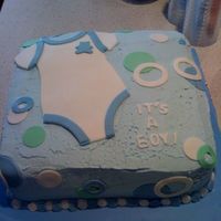 It's A Boy This is a baby shower cake I made for a friend. I covered it in bc frosting with cut outs of a onesie and circles with fondant.