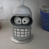 Bender From Futurama yellow cake w/ chocolate buttercream. Covered in fondant. Gumpaste for the goggles and antenna...thanks for looking!