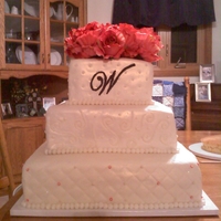 Ivory Wedding Cake Ivory pearlized fondant with buttercream monogram. (Flowers are silk.)