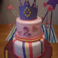 Granddaughter's 2Nd Birthday Cake Fashioned after a pinkcakebox cake. First tiered cake. Tried using rolled buttercream - never again!! Crown made from fondant.